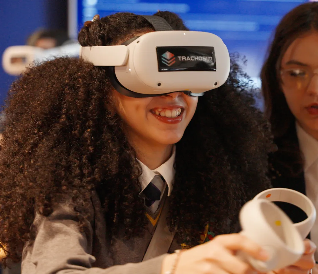 School pupil smiling whilst using a Goggleminds Trachosim VR headset at a FutureMinds workshop